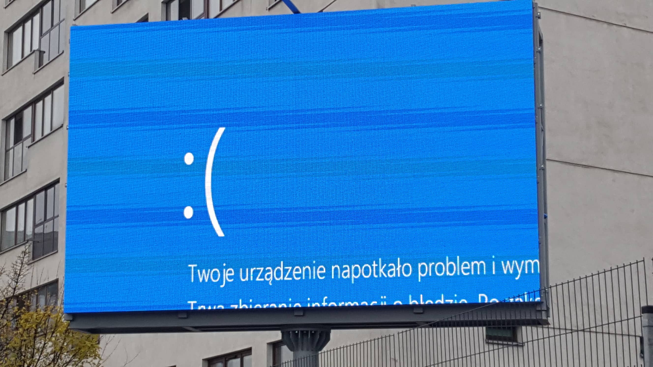 electronic ad billboard showing the windows blue screen of death