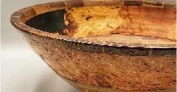 This 17 by 6.5" (43 x 16.5 cm) cherry burl bowl is finally done.  It has two rings of walnut.  The top ring has an inlay of hard cherry.  The voids in the burl have been filled with tinted epoxy.