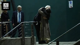 Julian Assange reunites with family as he arrives in Canberra