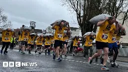 Hundreds take part in annual coal carrying race - BBC News